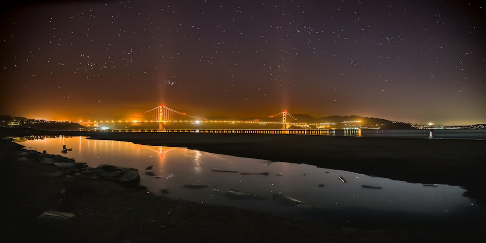 a night view of a bridge over a body of water