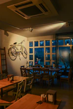 Cozy interior of Le Postillon with warm lighting and rustic wooden tables.