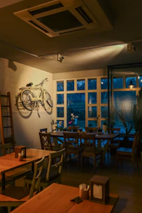 Cozy interior of Le Postillon with warm lighting and rustic wooden tables.