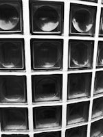 Close-up of a sleek glass block with light reflecting off its smooth surface.