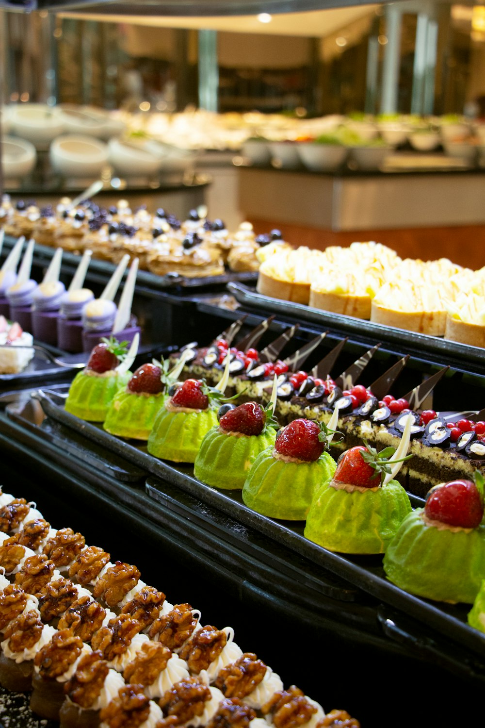 a variety of desserts on display in a buffet