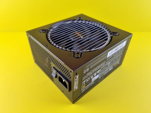 a black computer case sitting on top of a yellow table