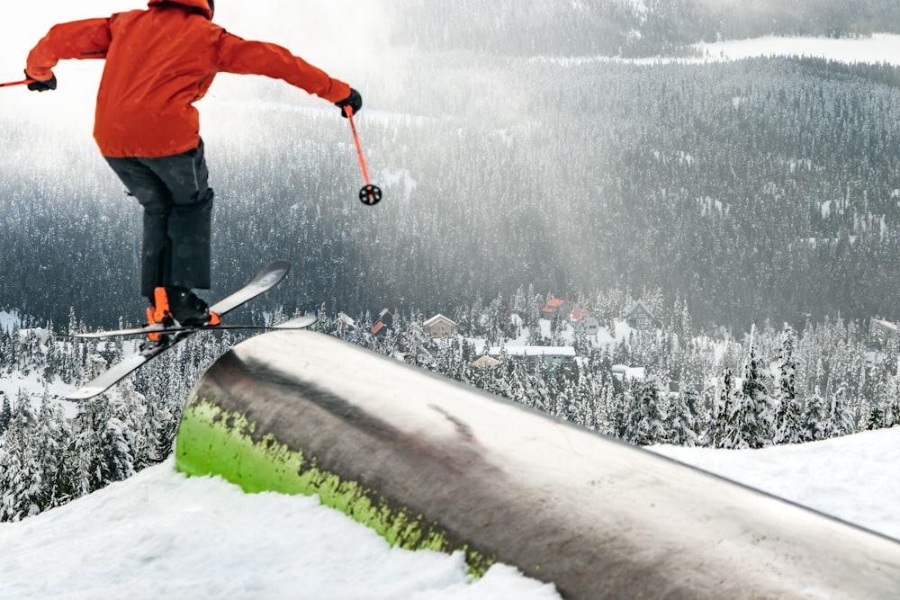 a man riding skis down the side of a snow covered slope