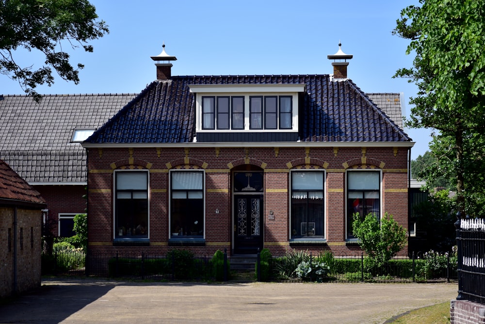 a large brick house with a black gate