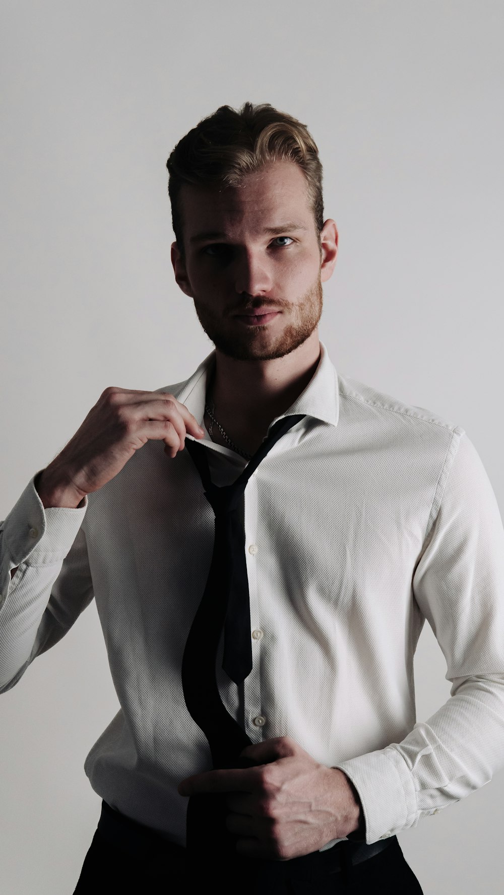 a man in a white shirt and black tie