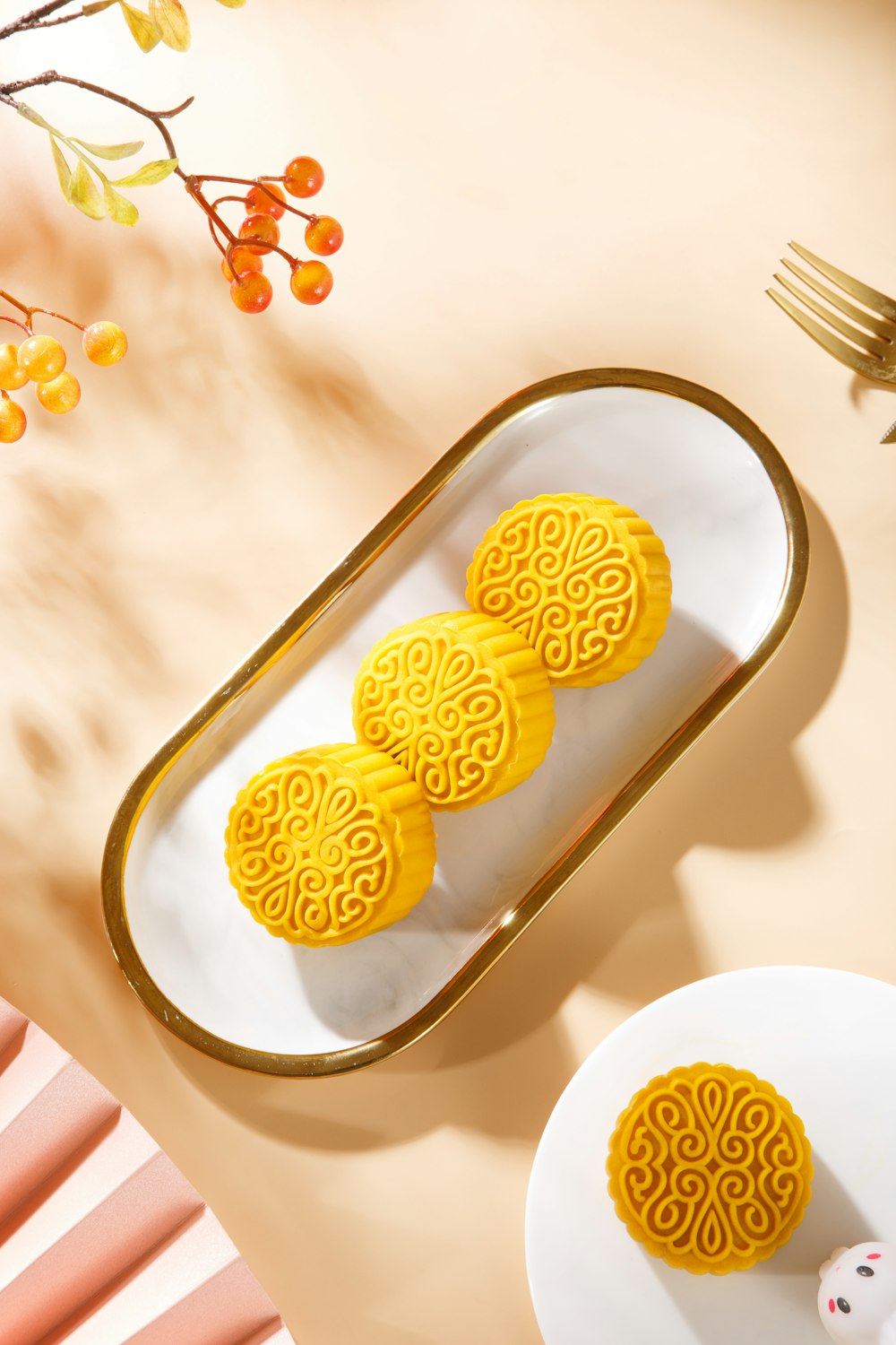 three yellow cookies sitting on top of a white plate