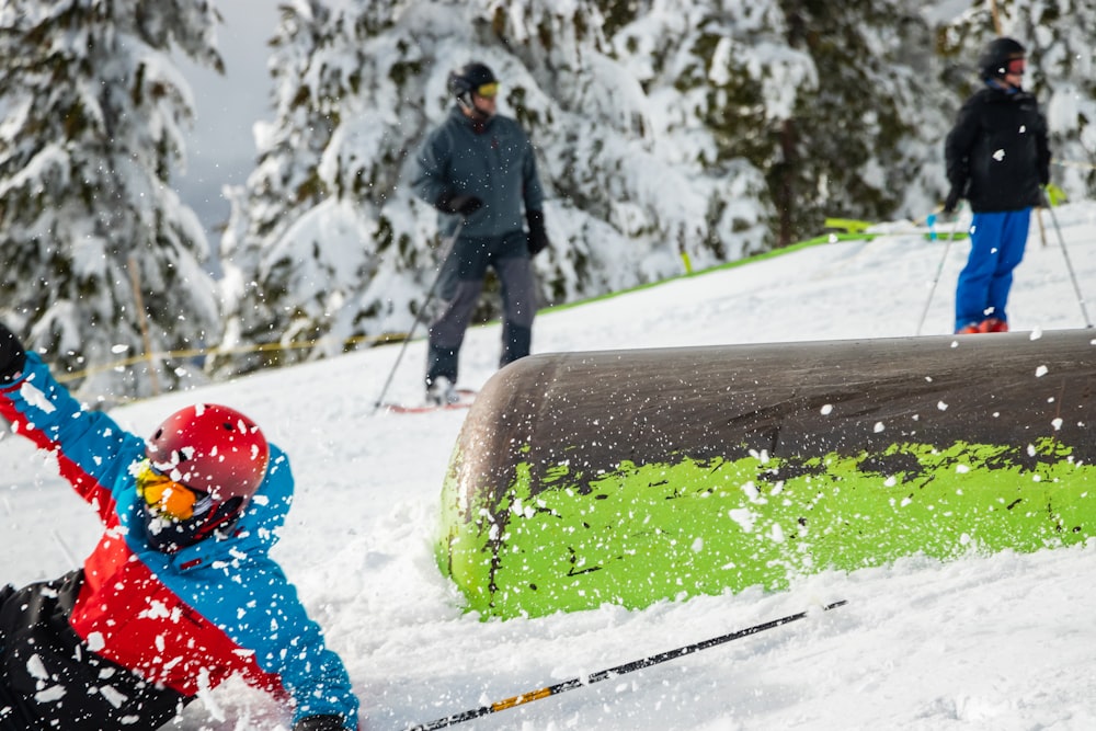 a young child riding skis down a snow covered slope