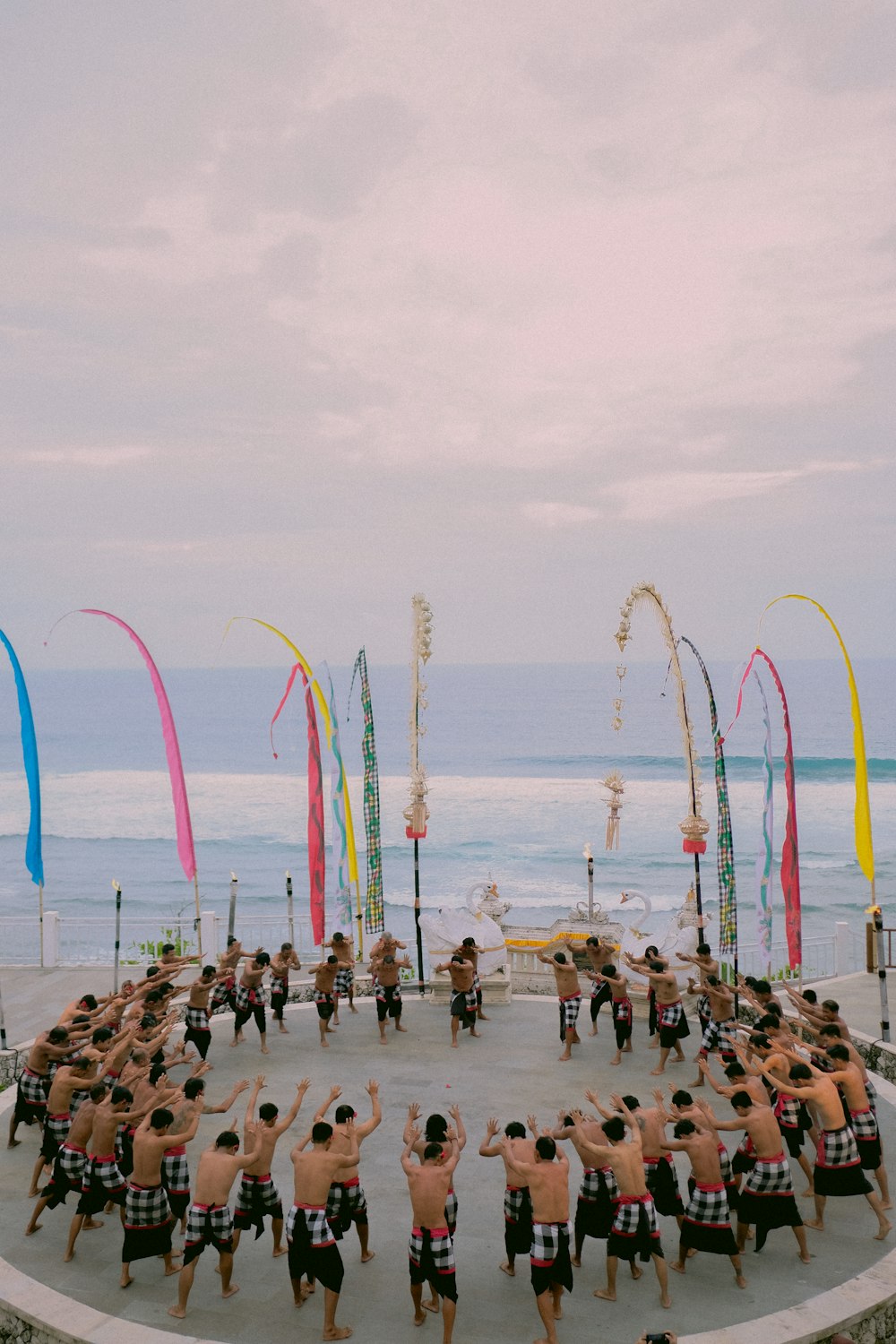 a group of people standing in a circle on a beach