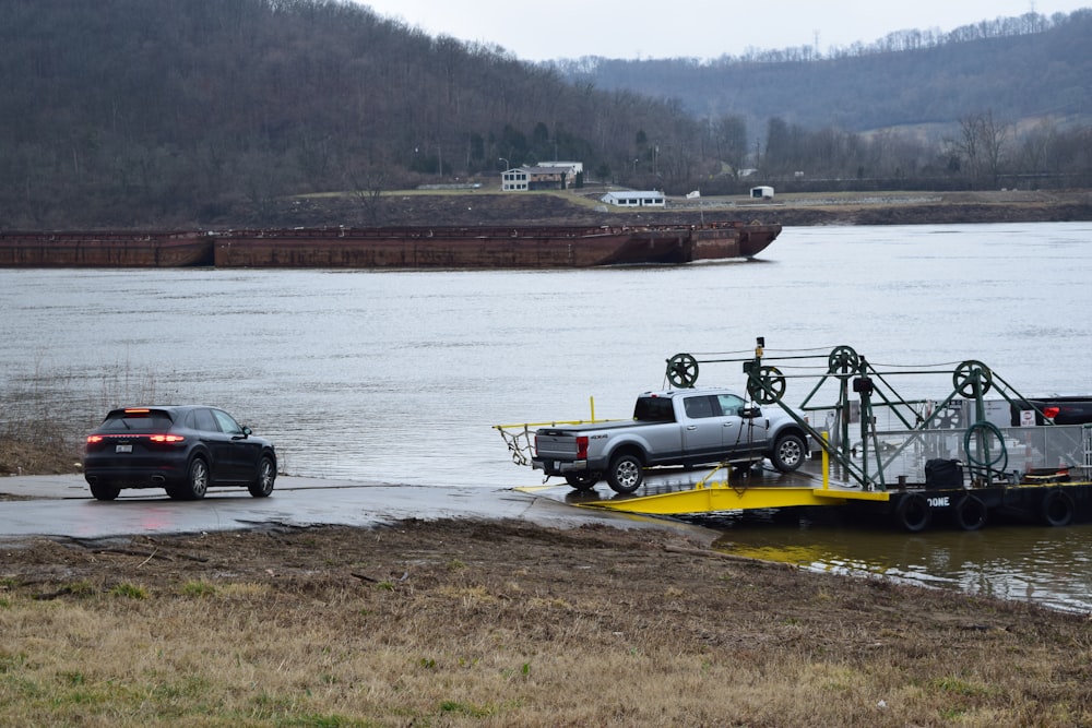 a tow truck towing a car across a body of water