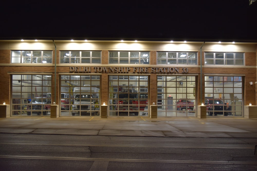 the front of a building at night with lights on