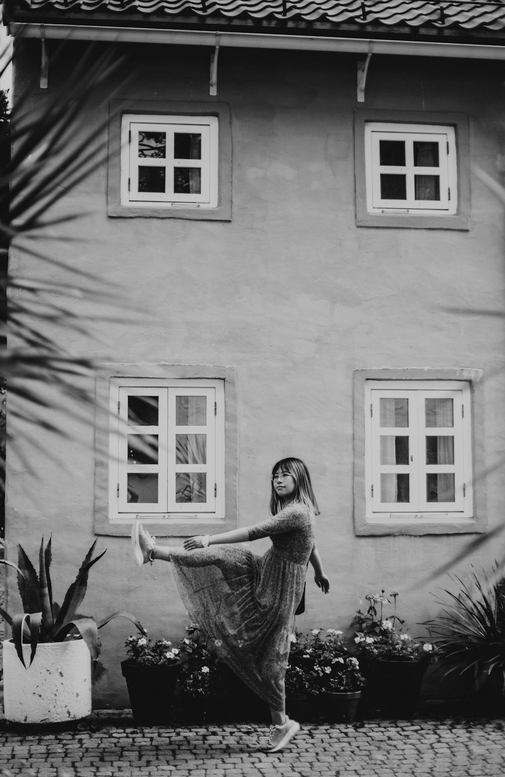 a woman standing in front of a house