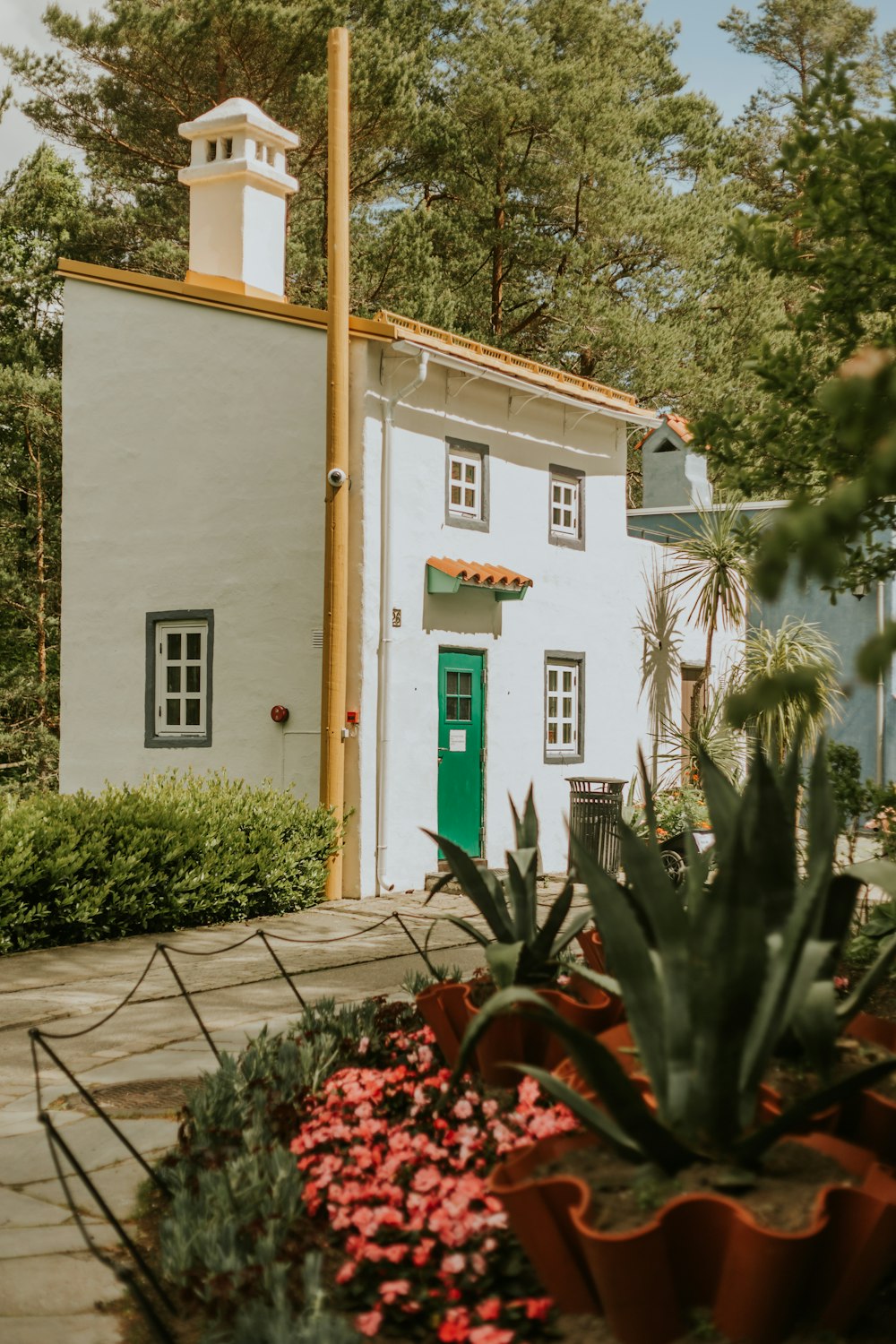 a small white house with a green door