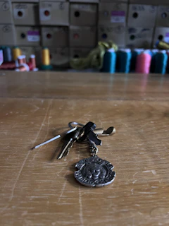 A set of 3D printed custom-designed keychains arranged neatly on a wooden surface