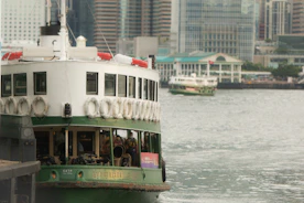 A modern automated ferry docking at a bustling harbor