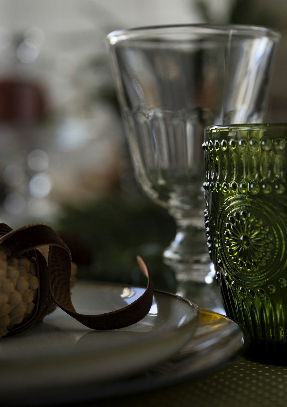 a green glass sitting on top of a white plate