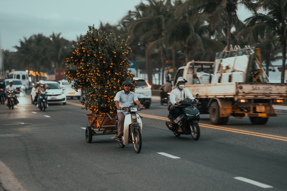 a group of people riding motorcycles down a street