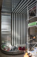 a room filled with lots of metal pipes