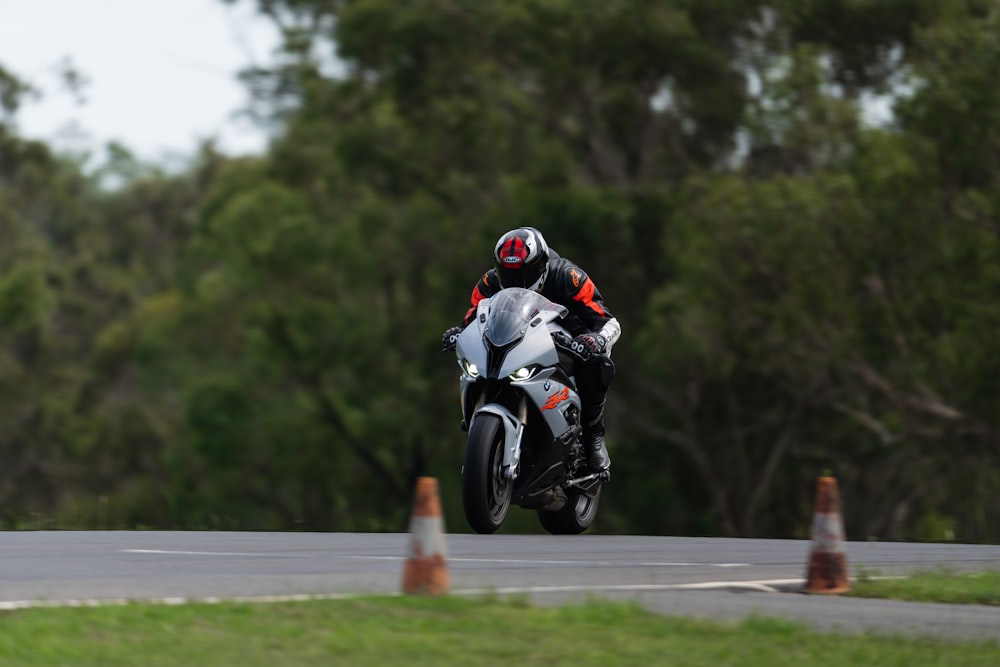 a man riding a motorcycle down a curvy road