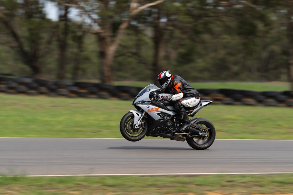 a man riding a motorcycle down a curvy road