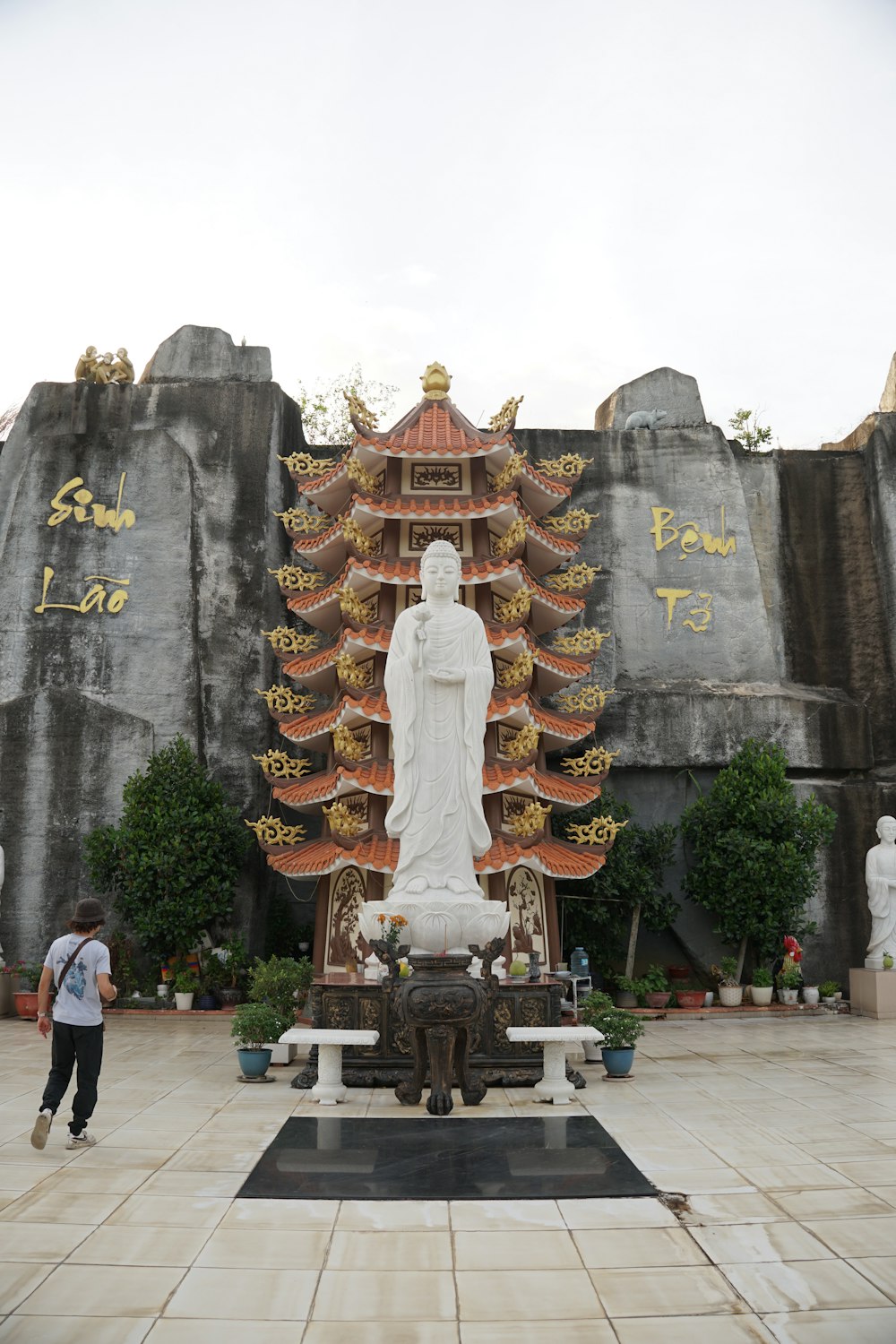 a statue of a person standing in front of a building