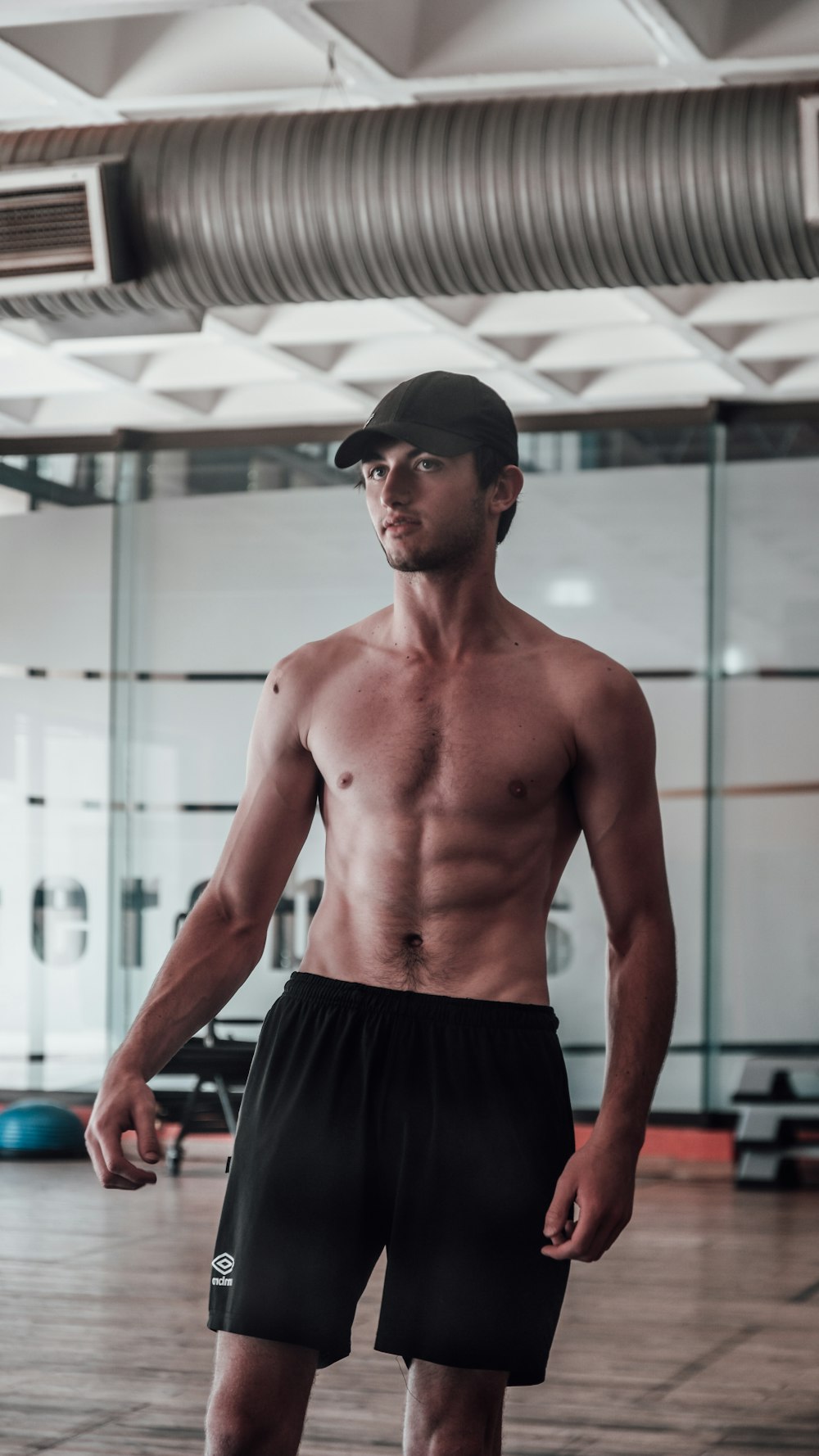 Un uomo senza camicia in piedi in una palestra