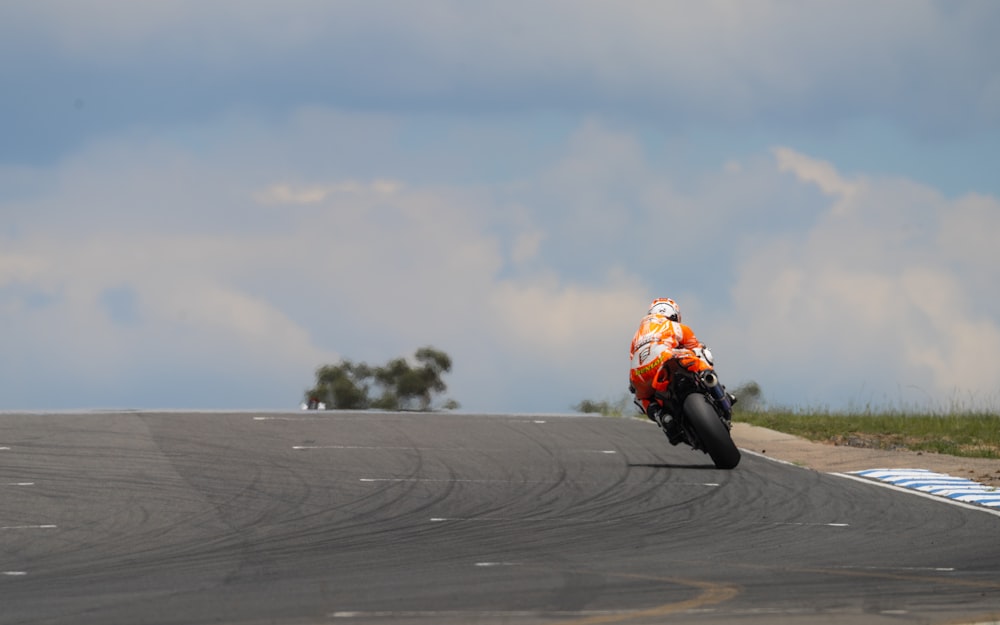 a person riding a motorcycle on a race track