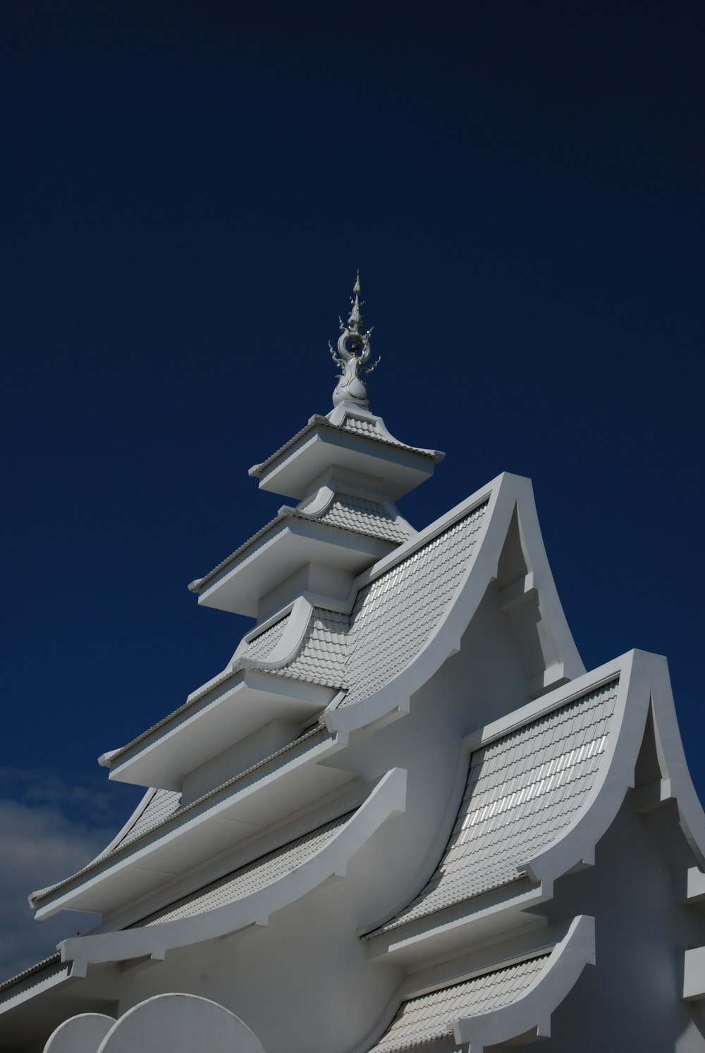 a tall white building with a sky background