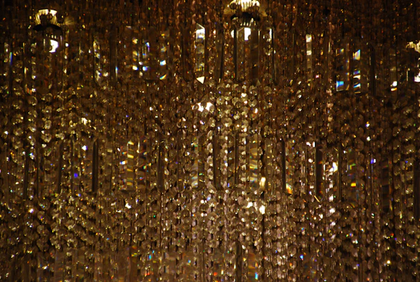 Close-up of sparkling golden accents reflecting warm light in a hotel room.