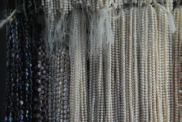a bunch of beads hanging on a wall