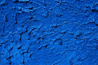a close up of a blue painted wall
