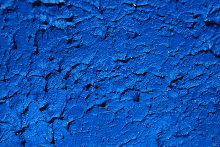 a close up of a blue painted wall