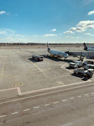 A busy airport apron with Aviaenergo staff coordinating aircraft ground services under clear blue skies.