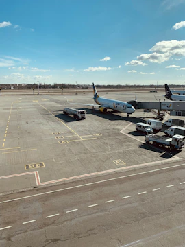 A busy airport apron with Aviaenergo staff coordinating aircraft ground services under clear blue skies.