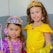 A joyful group of children dressed in Disney-themed costumes at a colorful birthday party.