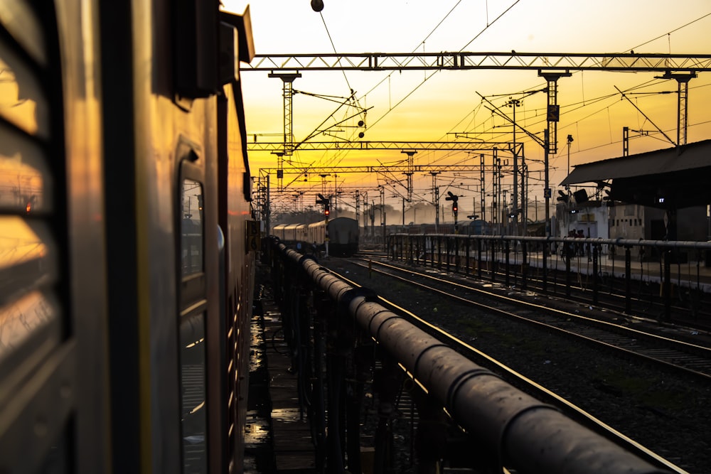 a train traveling down train tracks next to a train station