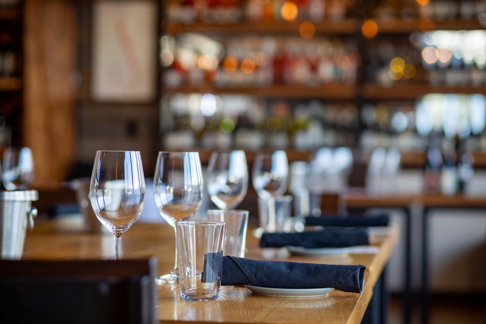 a wooden table topped with glasses of wine