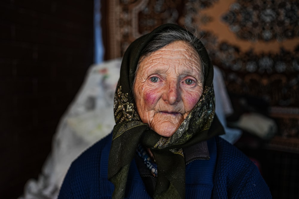 an old woman with a scarf around her neck