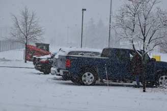 a couple of trucks are parked in the snow