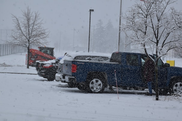 a couple of trucks are parked in the snow