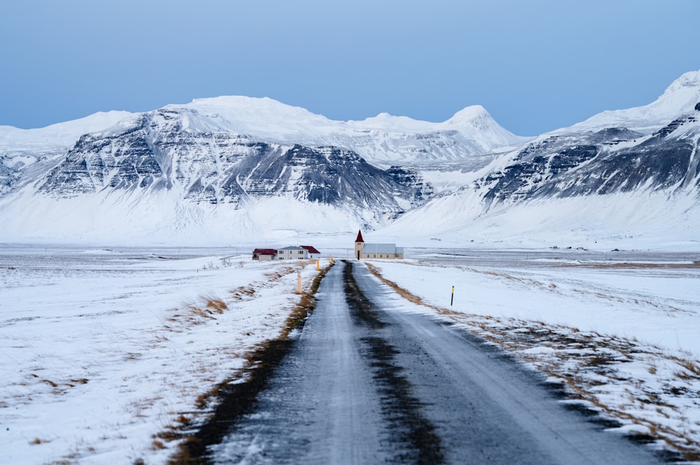 a road in the middle of a snowy landscape