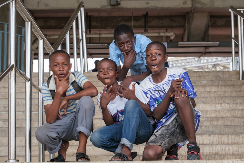 a group of children sitting on the steps of a building