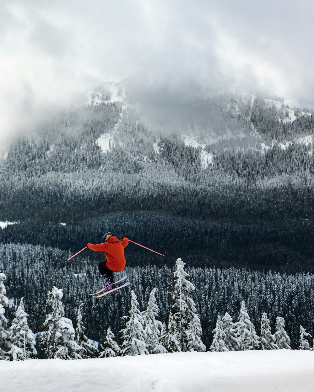 a man flying through the air while riding skis