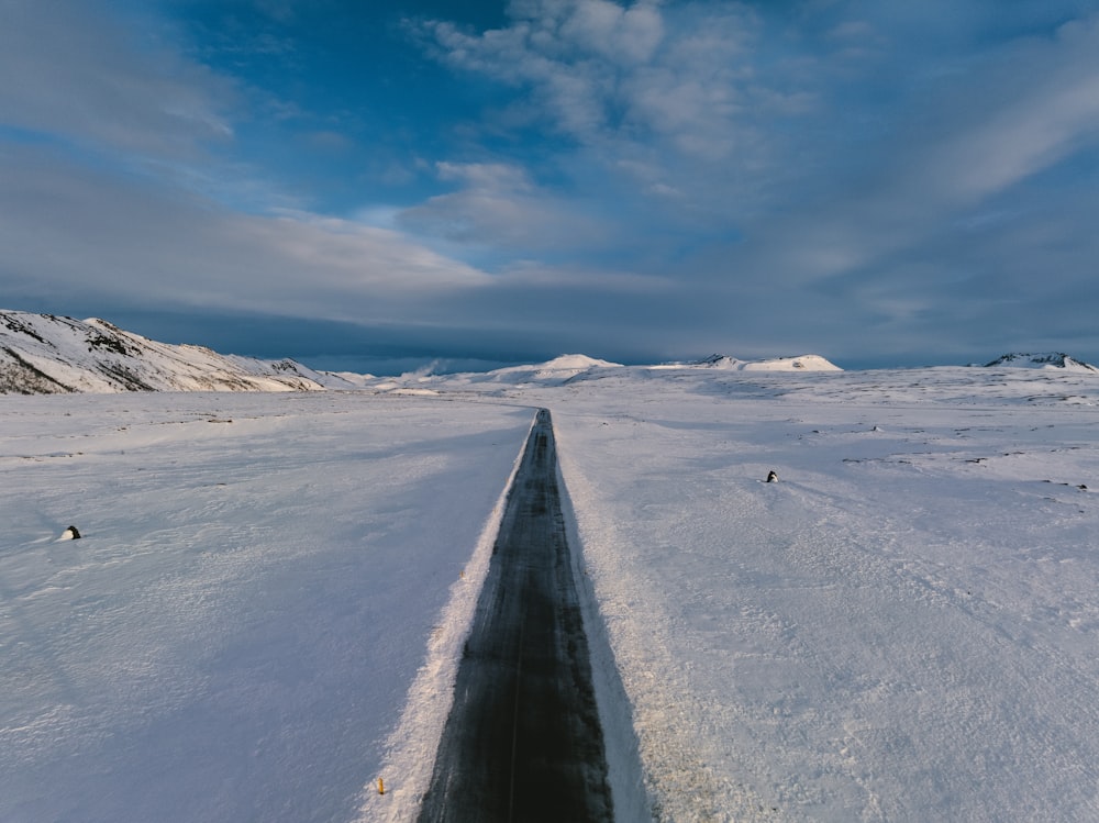 a long stretch of snow with mountains in the background