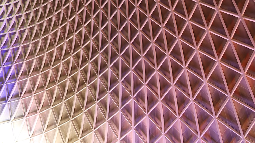 a close up of a metal structure with a blue light in the background