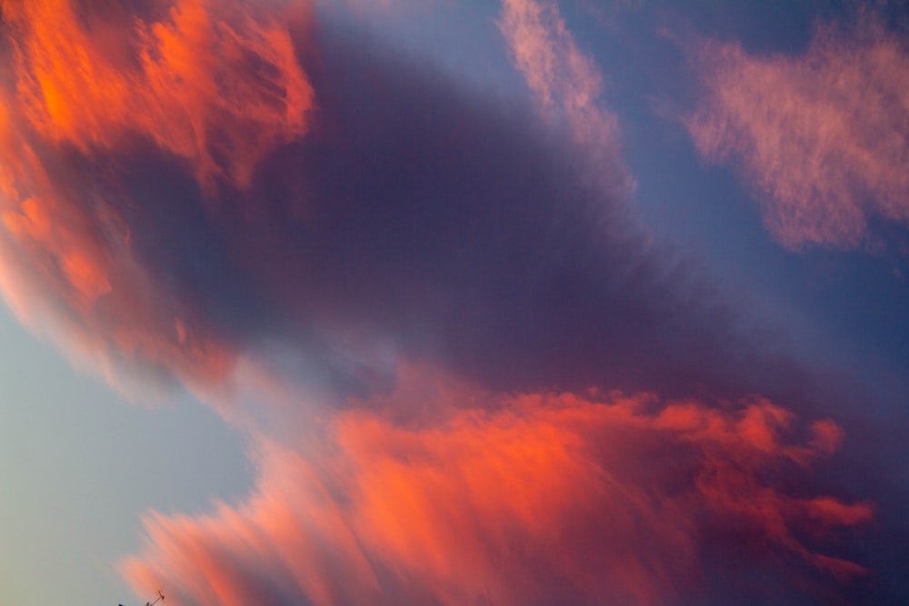 a plane flying in the sky with a lot of clouds