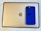 A blue smartphone case with a Nike logo and the phrase 'Just Do It' sits on top of a gold-colored tablet with an Apple logo.