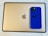 A blue smartphone case with a Nike logo and the phrase 'Just Do It' sits on top of a gold-colored tablet with an Apple logo.