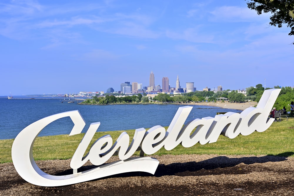 a large sign that says cleveland in front of a lake