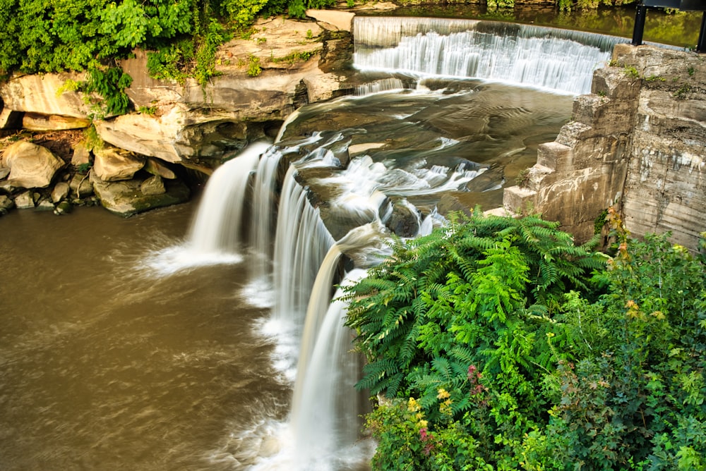 a waterfall with water cascading down it's sides