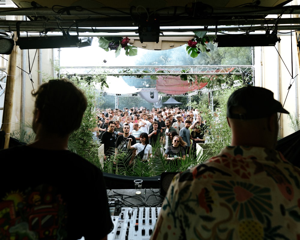 a group of people sitting in front of a large screen